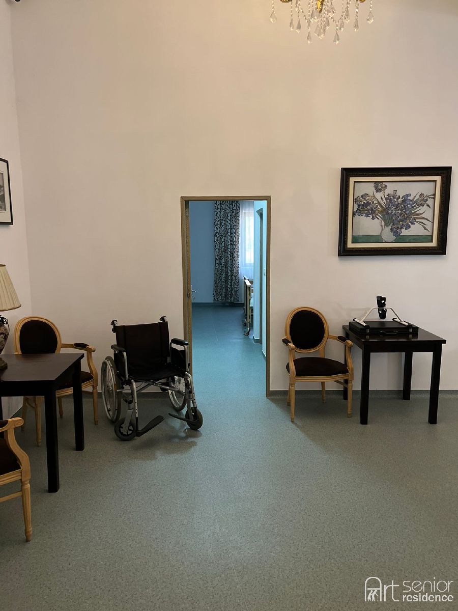 Colț de odihnă pe hol, cu masă și scaune tapițate